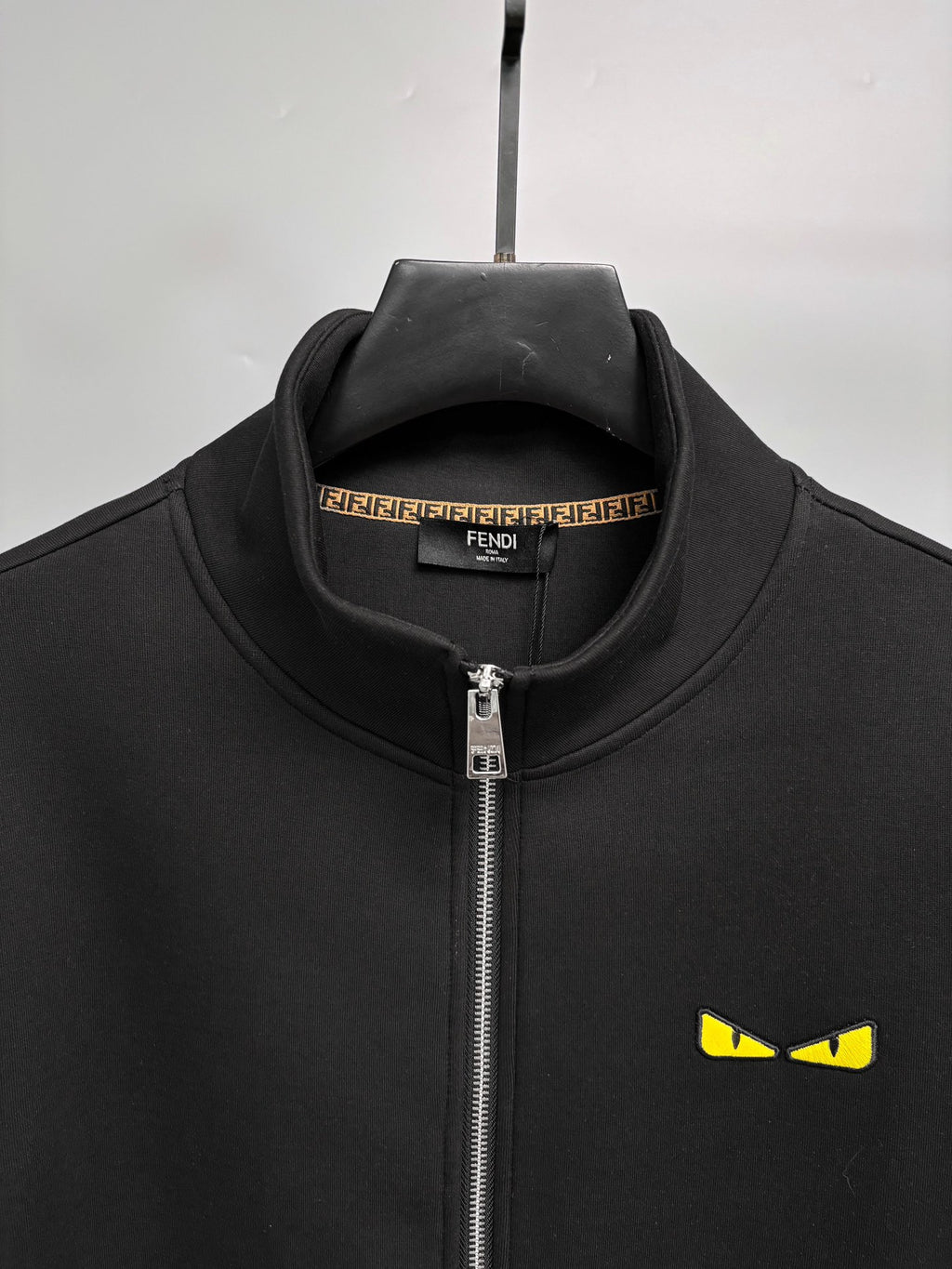 Fendi black zip-up sweatshirt collar with zipper and yellow eye logo