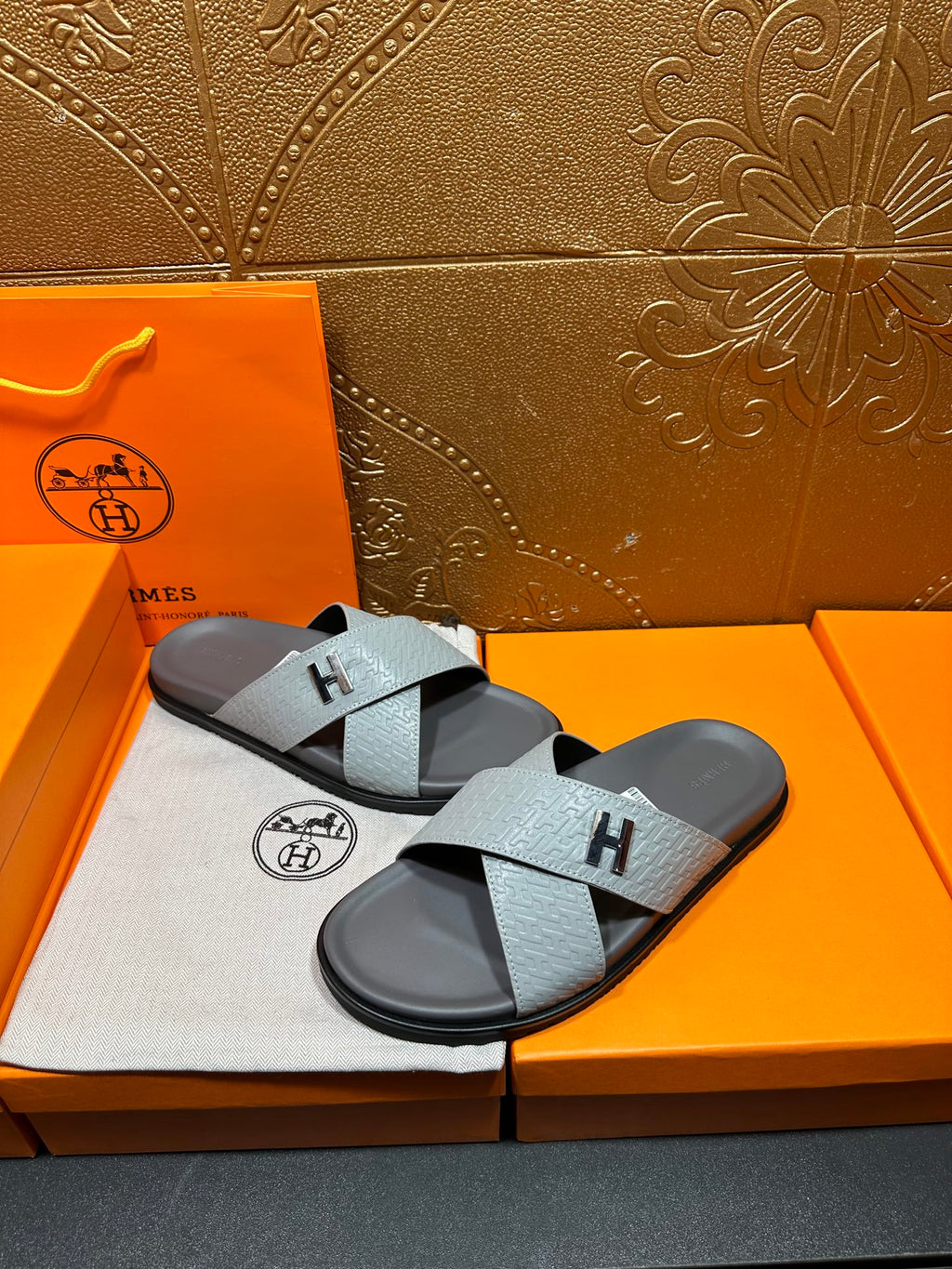 Hermes slide sandals, pair view; light blue textured straps with black H branding
