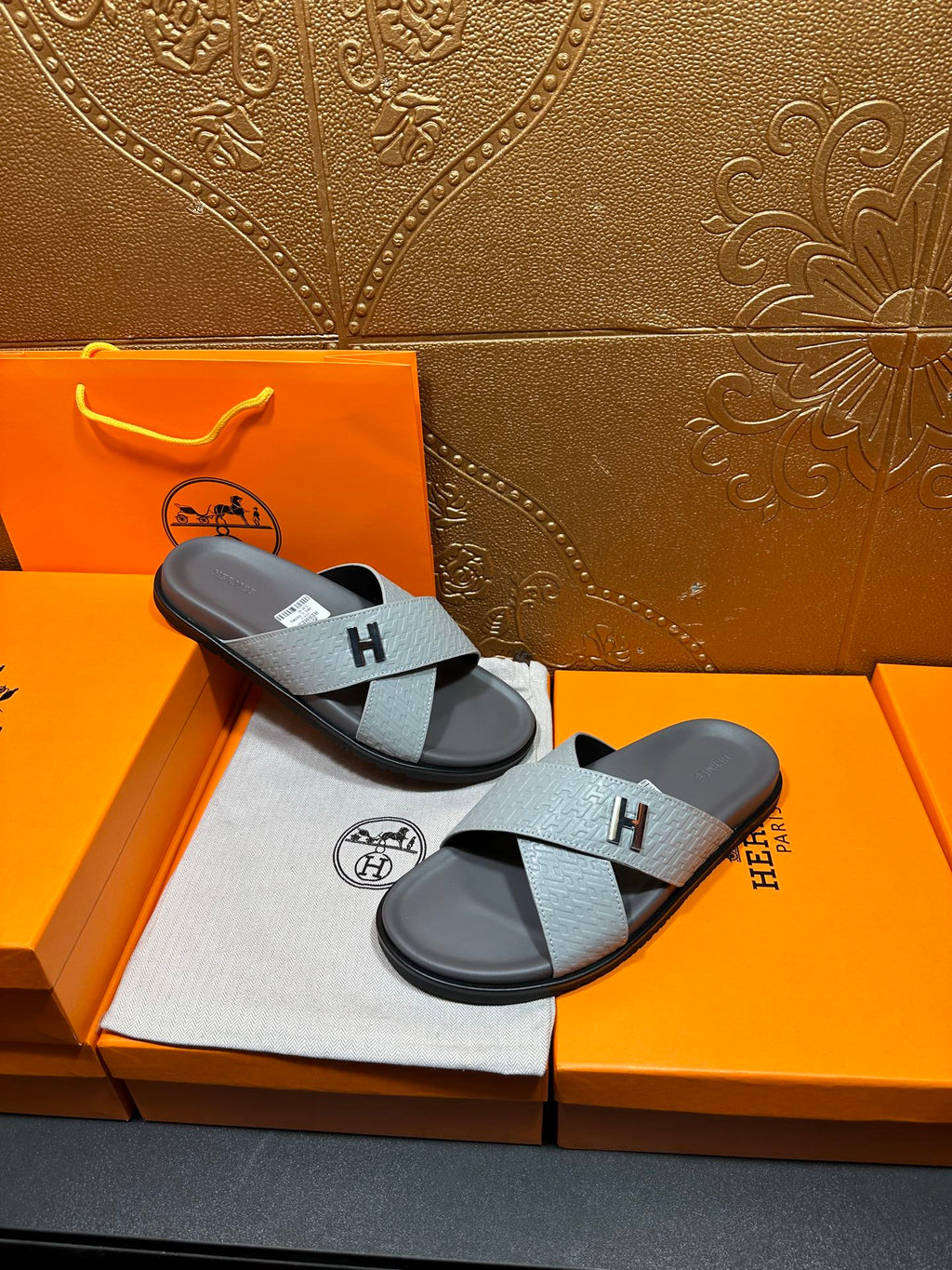 Hermes slide sandals, two sandals with light blue textured straps and dark soles
