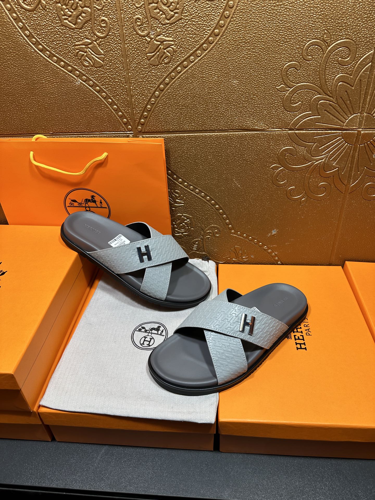 Hermes slide sandals, two sandals with light blue textured straps and dark soles