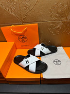 White and black H logo slide sandals with textured strap and open toe