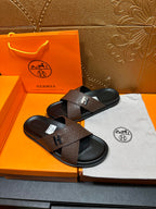 Brown leather slide sandals with black footbed and H buckle strap