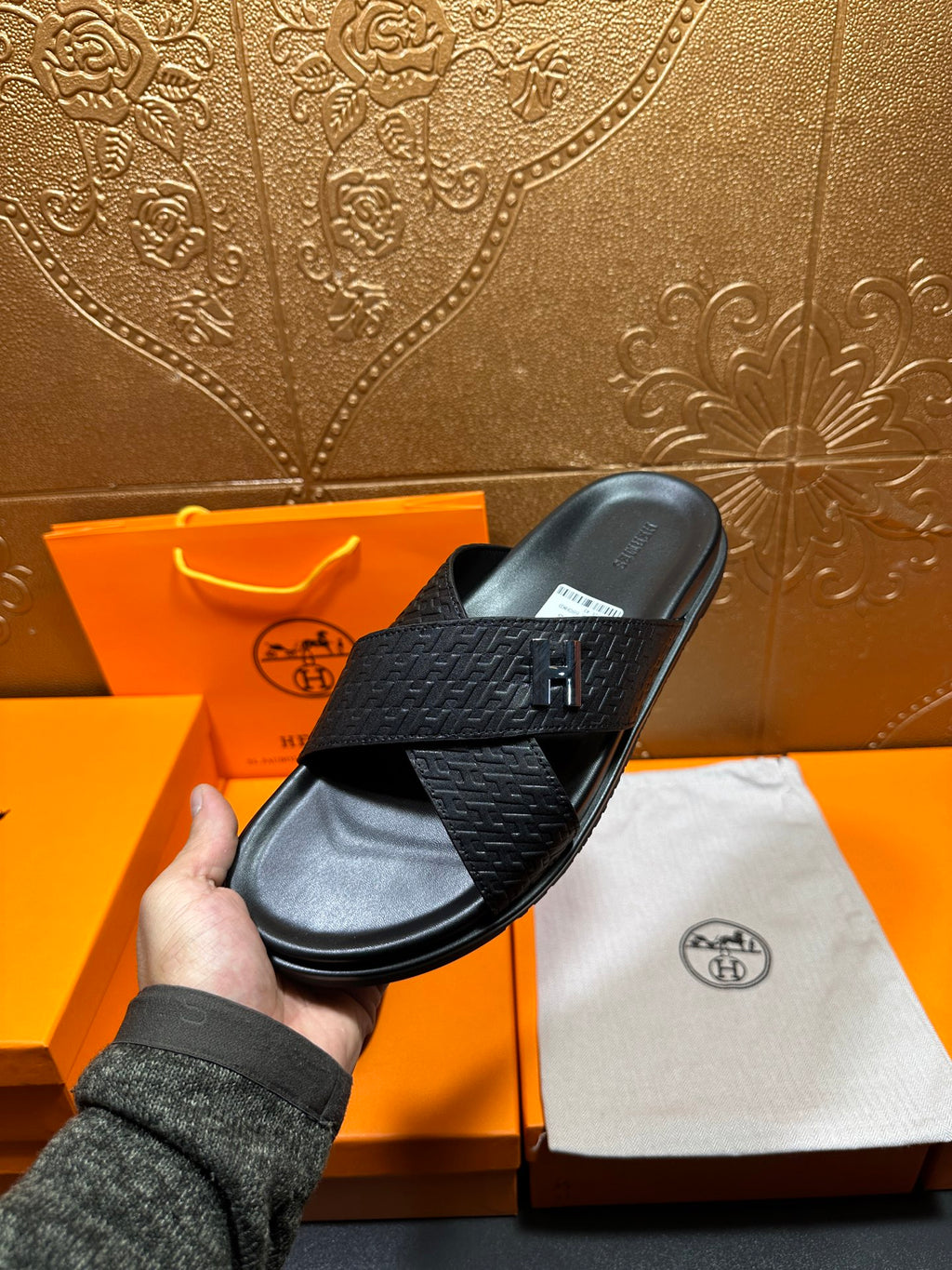 Black textured slide sandal with H buckle and thick flat sole