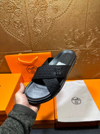 Black textured slide sandal with H buckle and thick flat sole