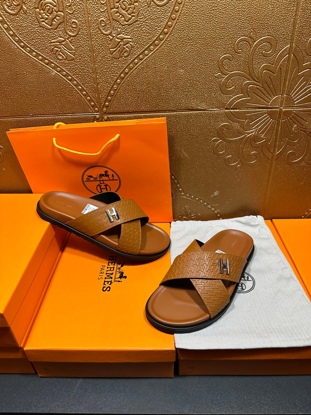 Hermes slide sandals with tan textured straps and H buckle, open-toe slides
