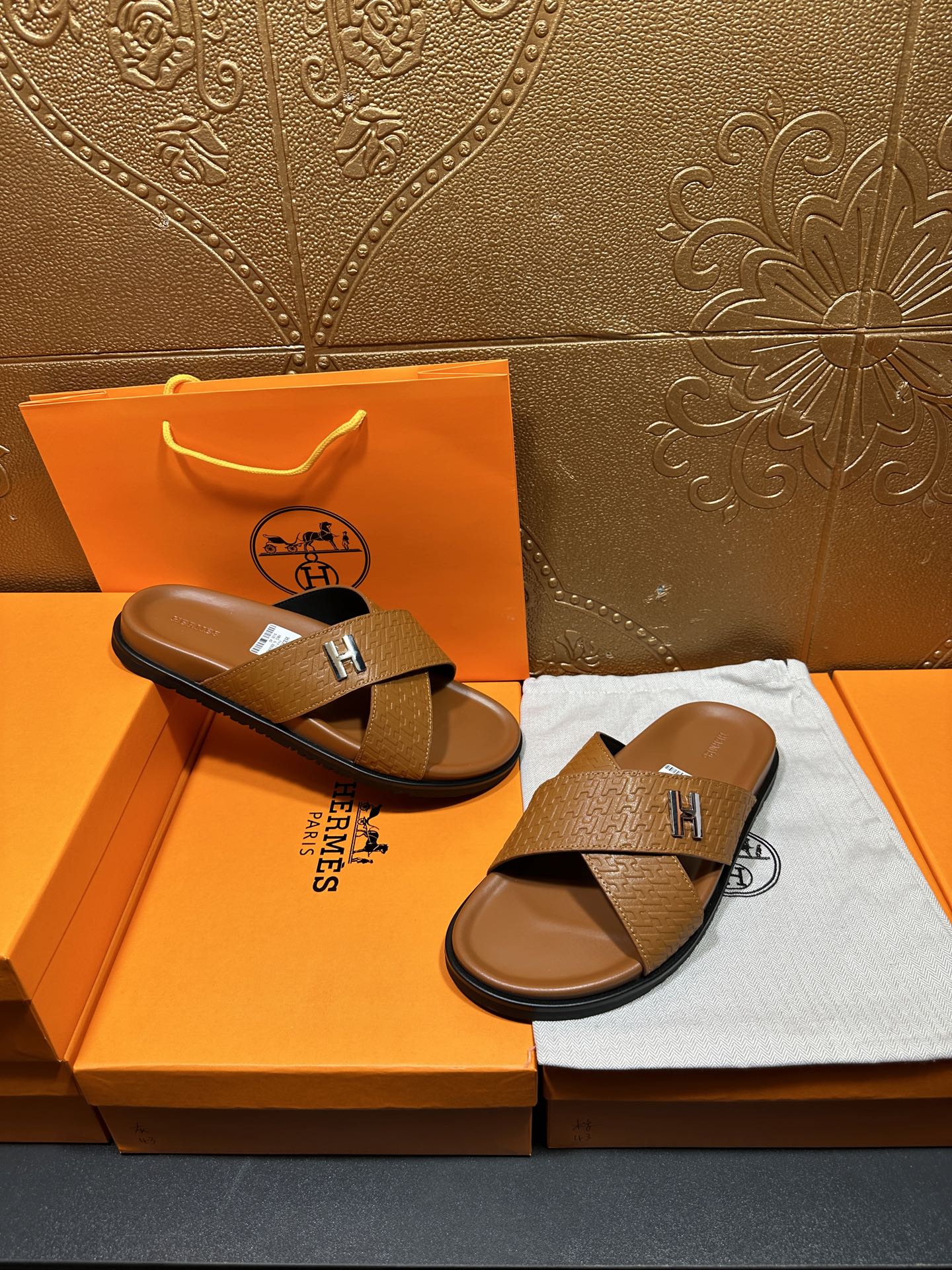 Hermes slide sandals with tan textured straps and H buckle, open-toe slides