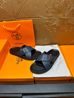 Blue slide sandals with embossed texture, H logo strap, black footbed, pair