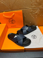 Blue slide sandals with H logo cross strap and black footbed, side angle pair