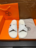 Hermes white leather slide sandals with cross straps and black H logo detail