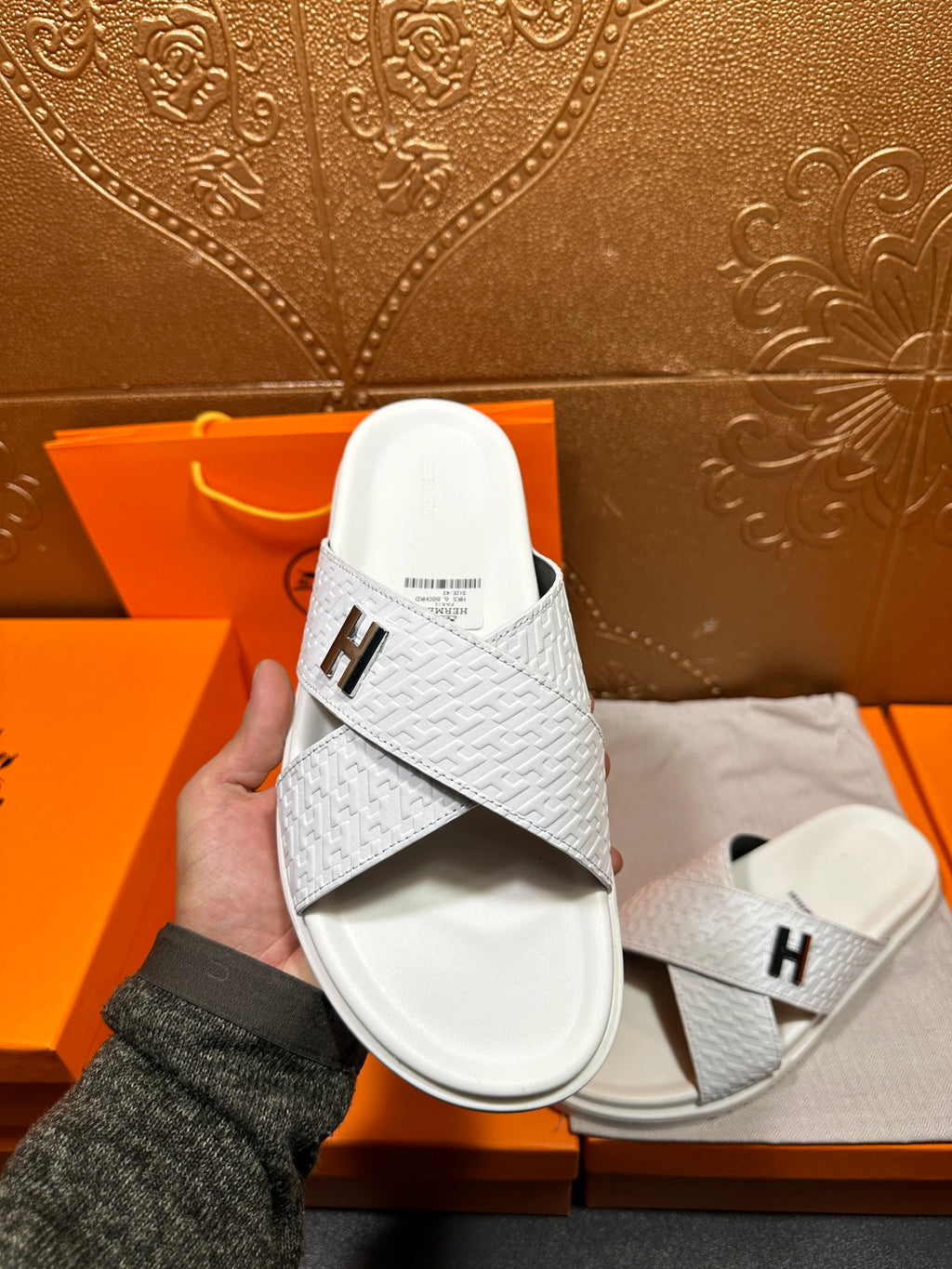Hermes white leather slide sandals with black H logo on textured upper