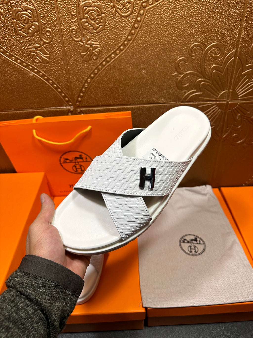 Hermes white slide sandal with black H logo on strap and cushioned sole