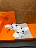 Hermes white slide sandals with black H logo straps on white footbeds