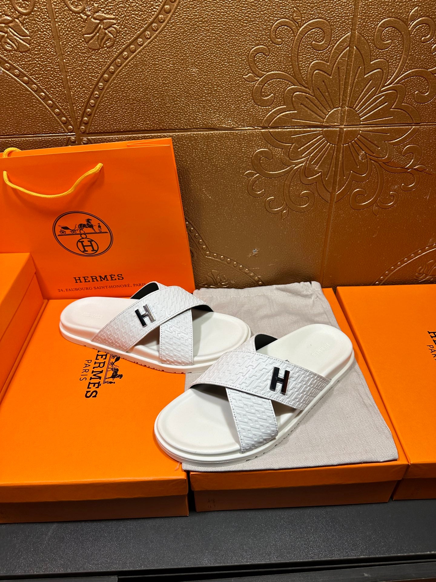 Hermes white slide sandals with black H logo straps on white footbeds