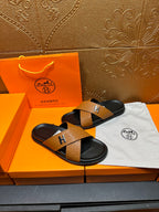 Brown textured leather slide sandals with black footbeds and stitched H strap
