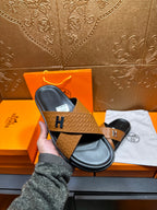 Brown textured leather slide sandals with black footbed and H logo strap