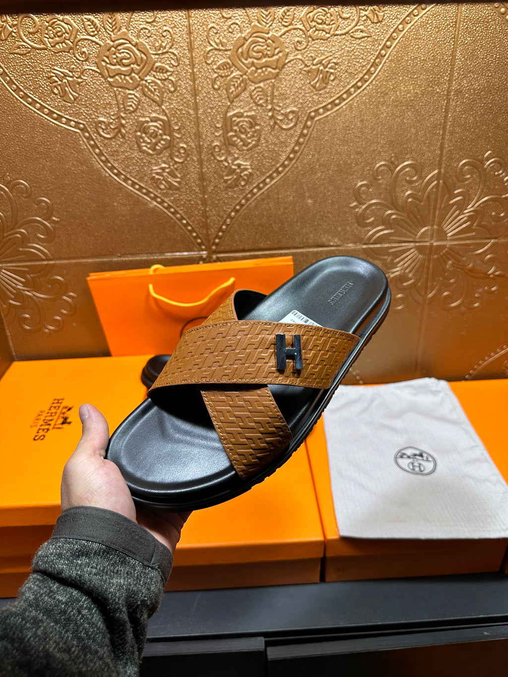 Brown textured leather slide sandals with black footbed and H logo strap