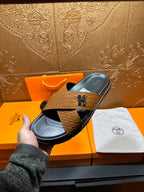 Brown textured leather slide sandals with black footbed and H logo strap