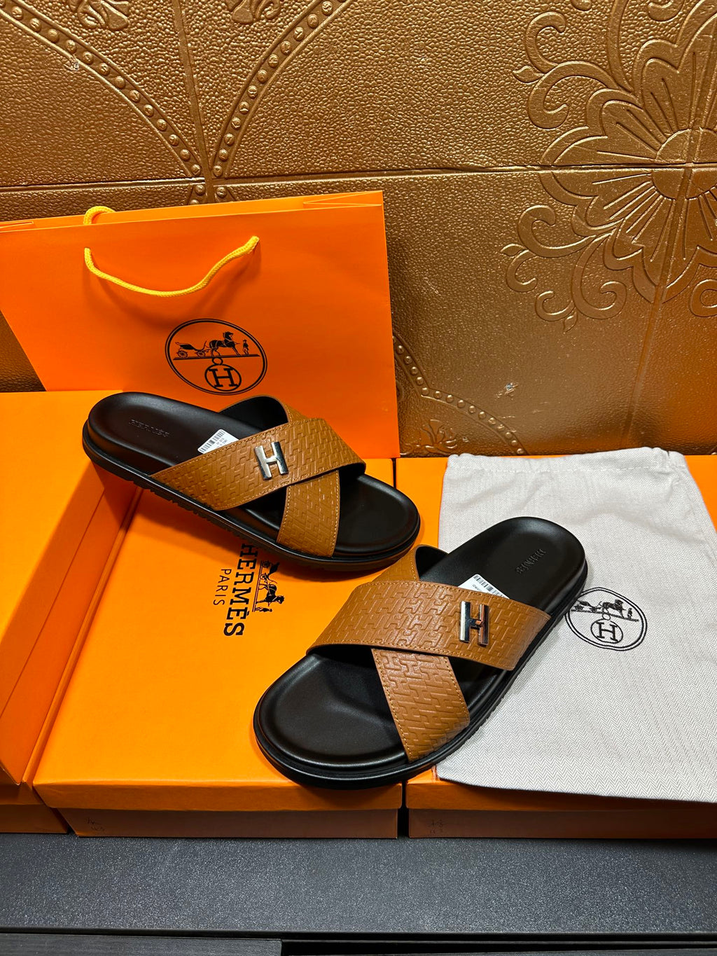 Brown textured leather slide sandals with black footbeds and H logo cross strap
