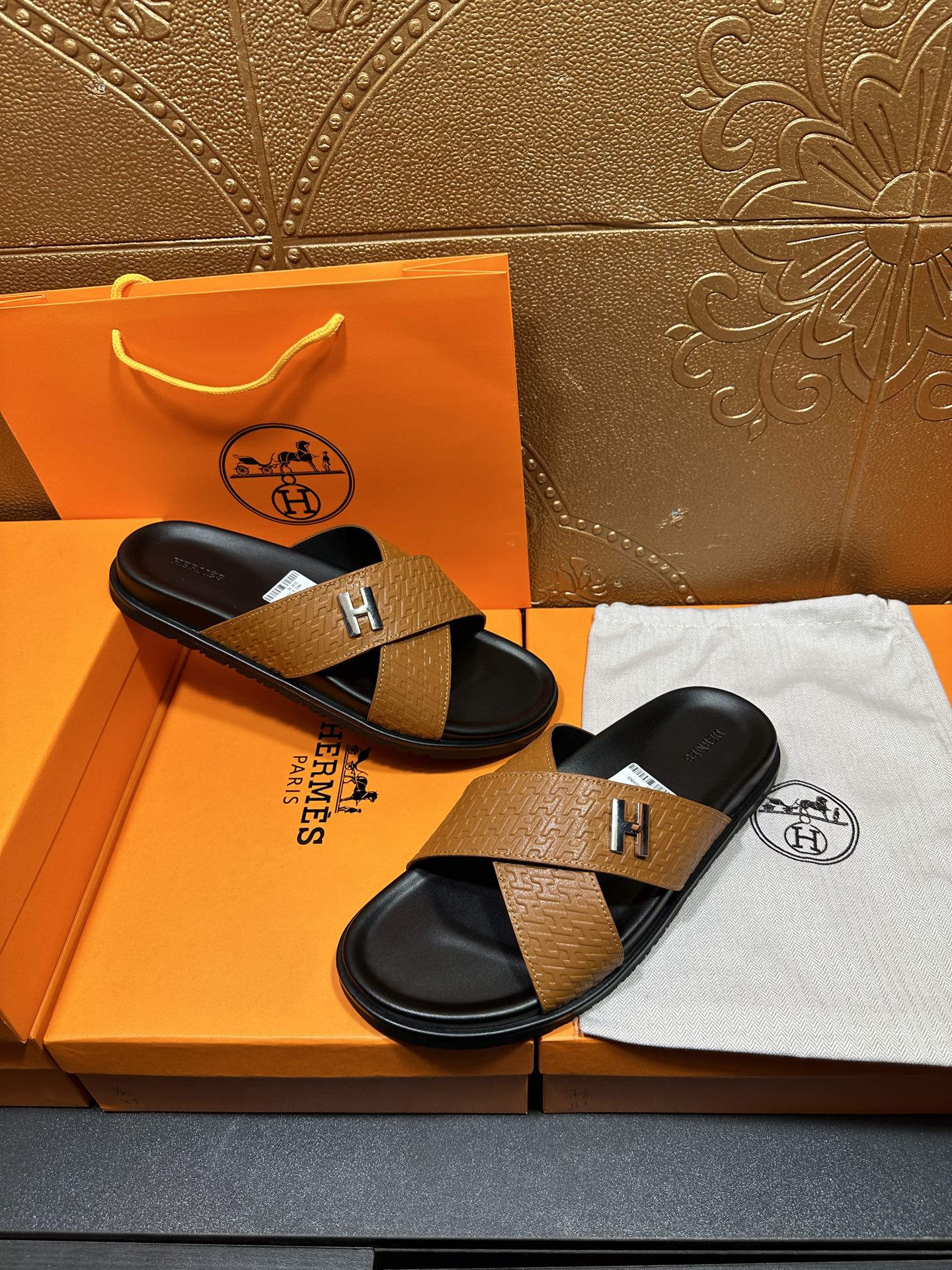 Brown textured leather slide sandals with black footbeds and H logo cross strap
