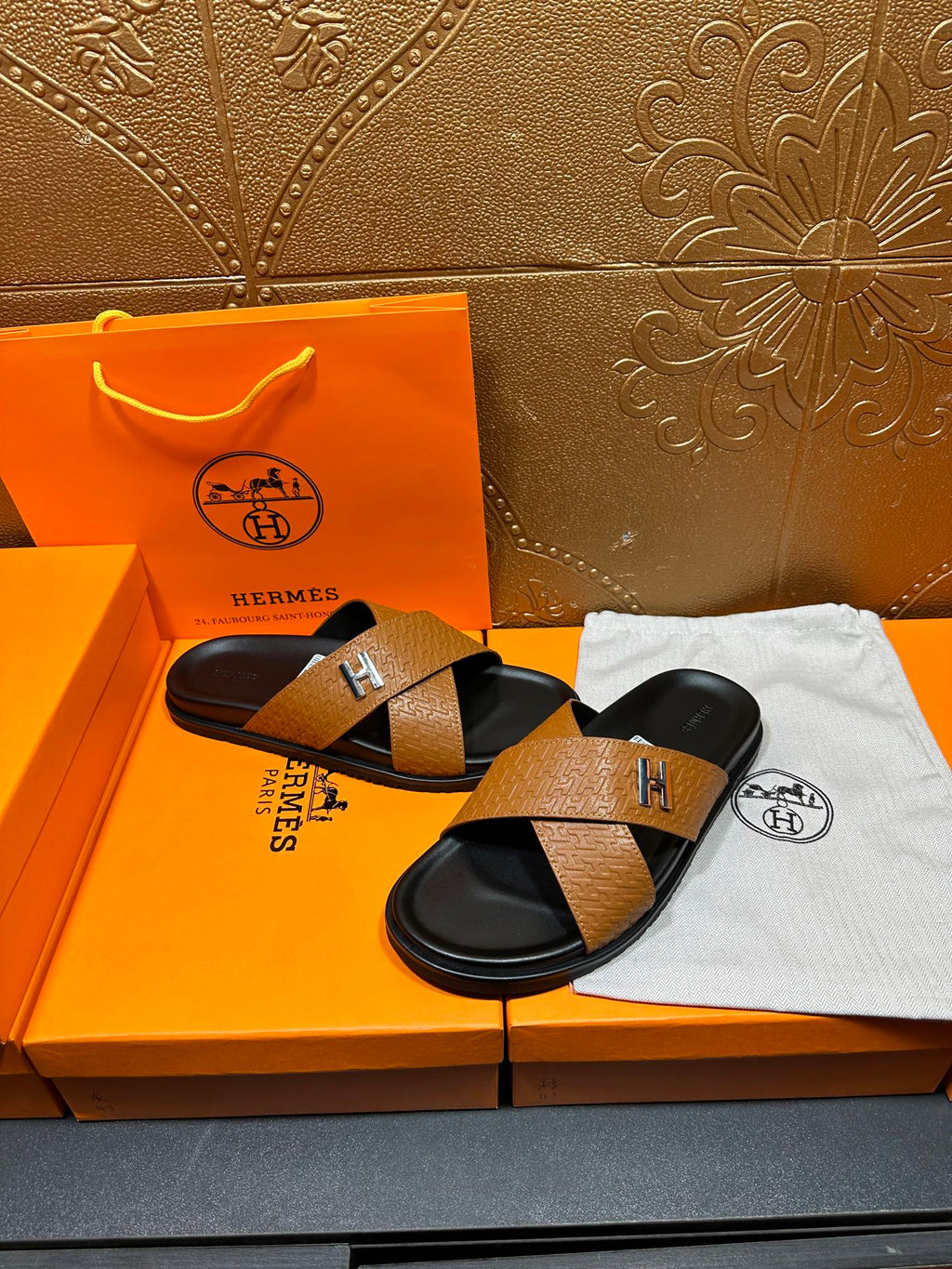 Brown textured leather slide sandals with black footbeds, H logo on cross strap