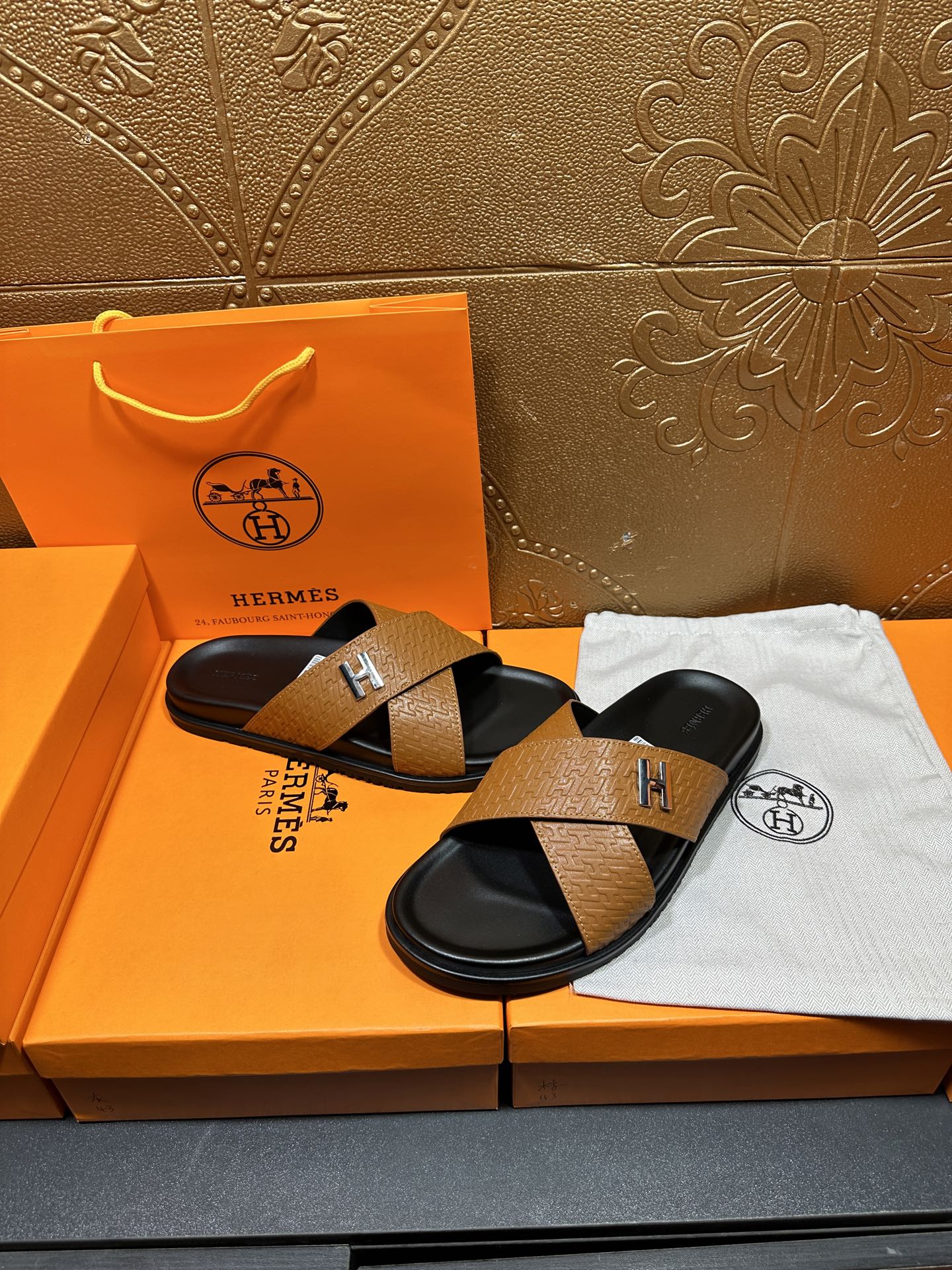 Brown textured leather slide sandals with black footbeds, H logo on cross strap