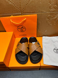 Brown textured leather slide sandals with black footbed and H logo strap