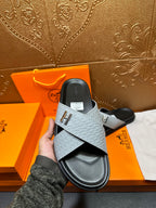 Hermes slide sandals on hand: light gray textured strap with H buckle, black base
