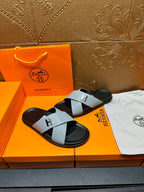 Hermes sandals with light gray textured straps and black footbed, H buckle front view