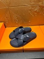 Pair of textured navy slide sandals with black H logo buckle