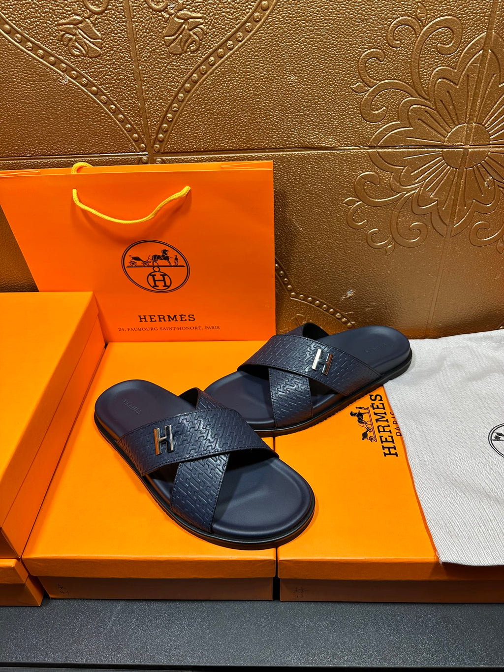 Navy textured slide sandals with H logo buckle and open toe straps