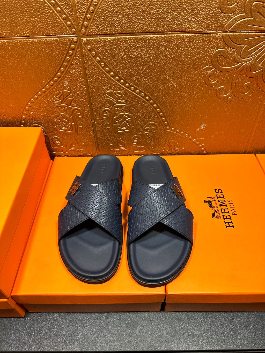 Textured navy slide sandals with H logo buckle and cross strap design