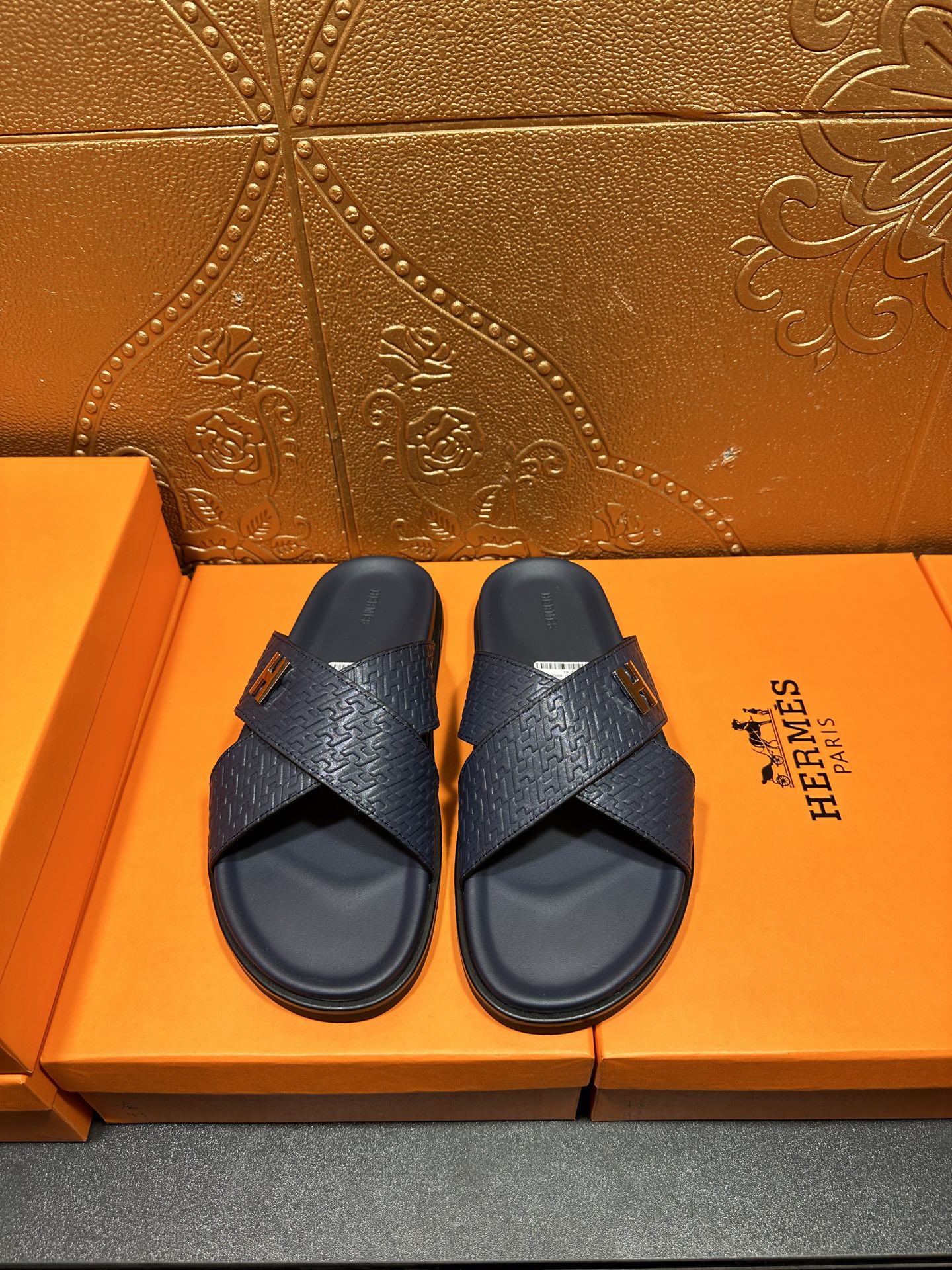 Textured navy slide sandals with H logo buckle and cross strap design