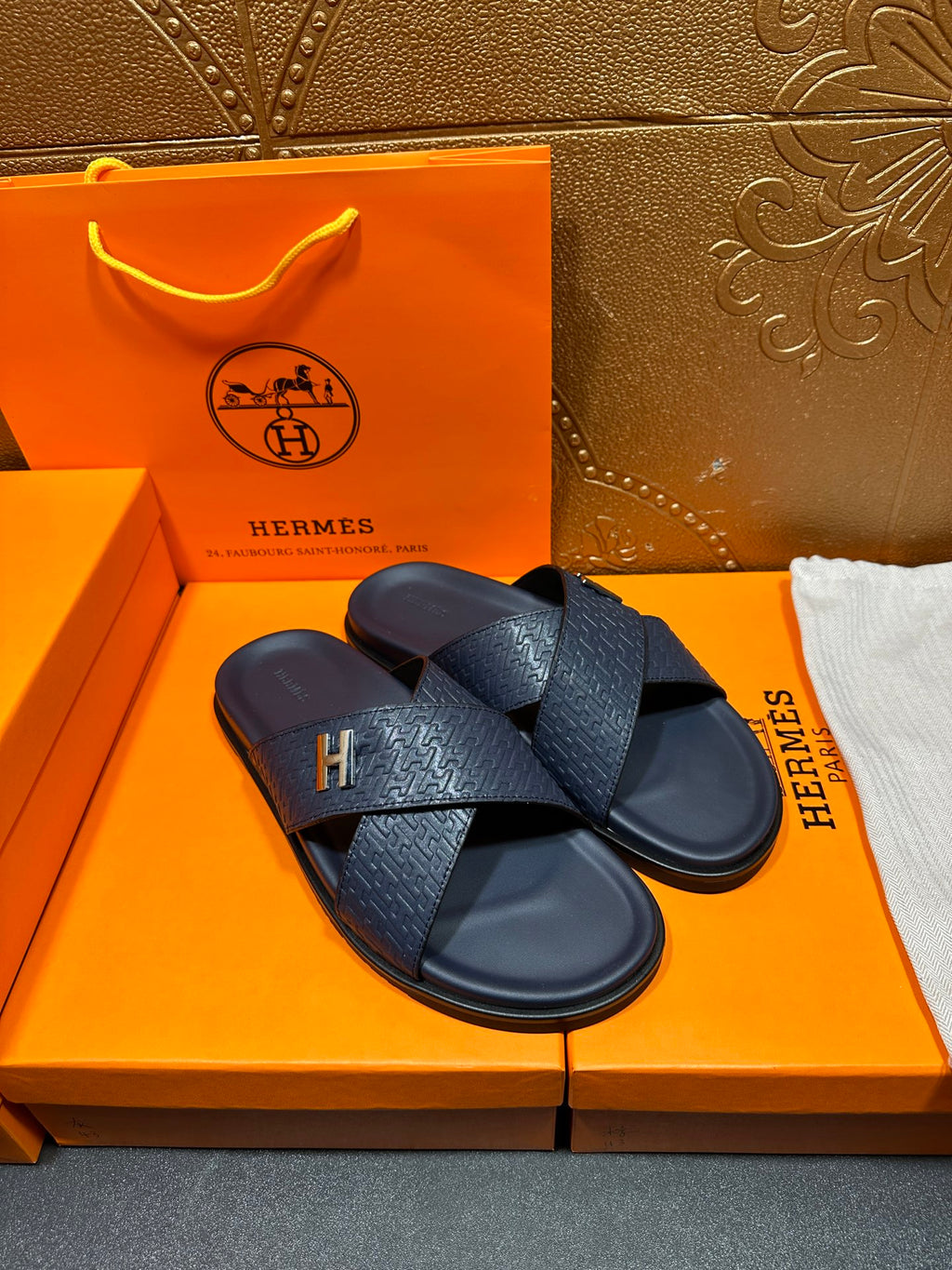 Navy textured slide sandals with H logo buckle on cross straps