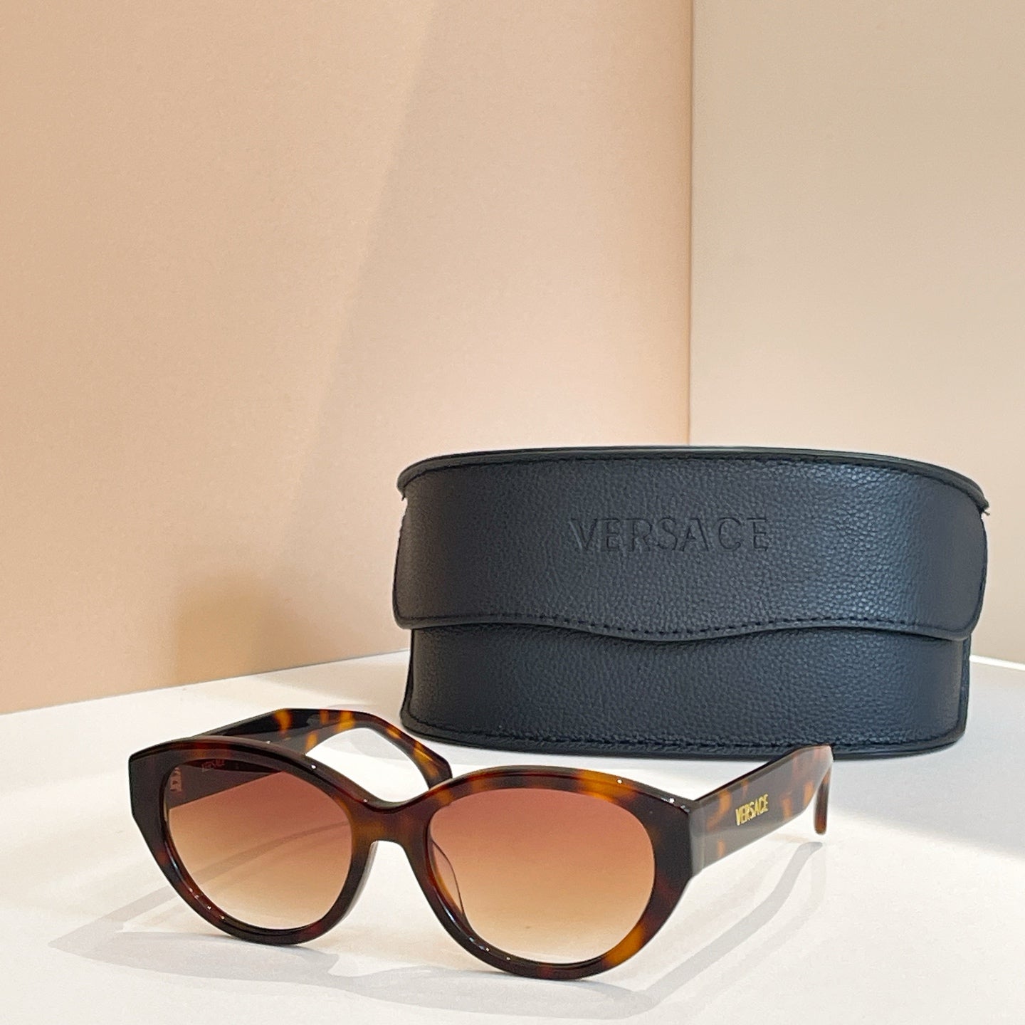 Versace sunglasses with tortoiseshell frames and amber lenses