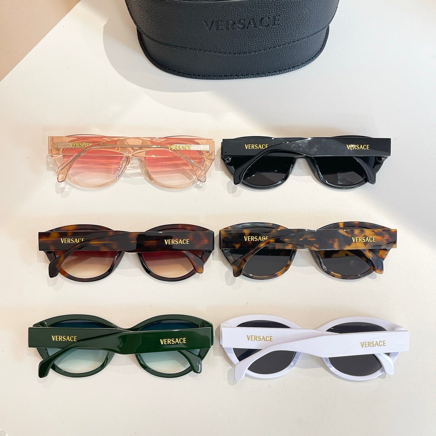 Assorted Versace sunglasses set with orange, black, tortoiseshell, green, and white frames