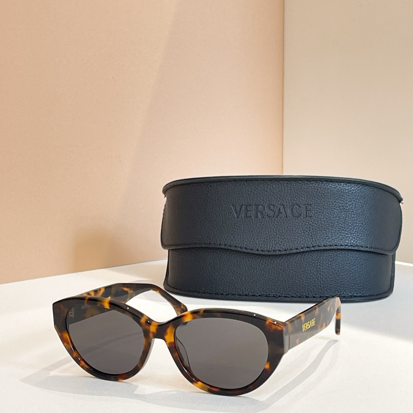 Versace sunglasses with tortoiseshell frames and dark brown lenses