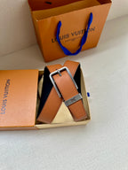 Louis Vuitton leather belt in box, tan strap with silver buckle and LV detail