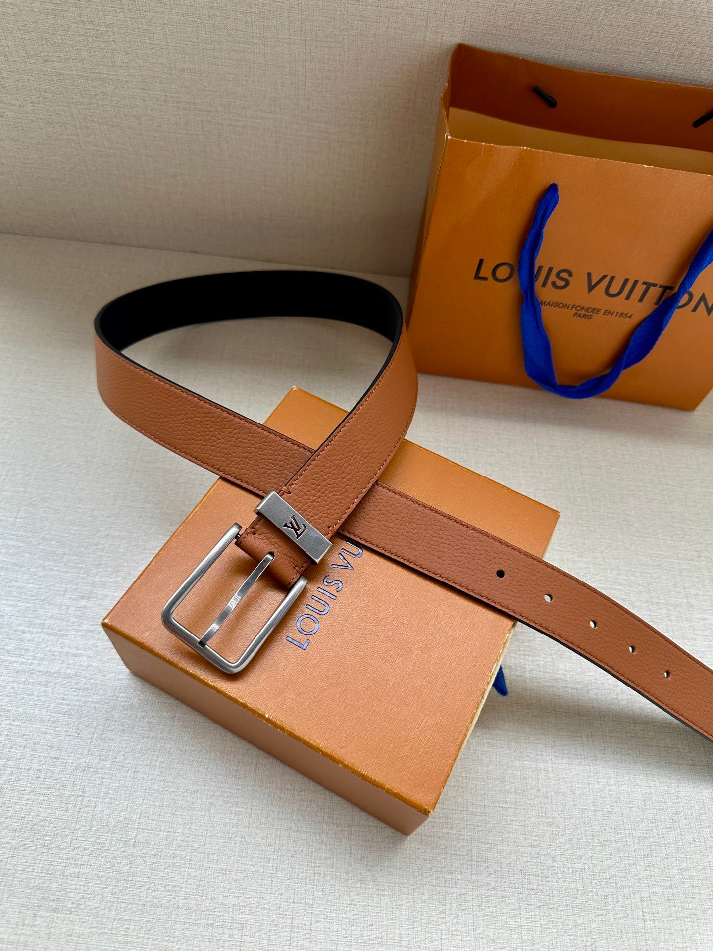 Louis Vuitton leather belt with tan strap and silver-tone buckle