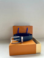 Louis Vuitton belt on box, dark blue leather strap with silver-toned buckle.