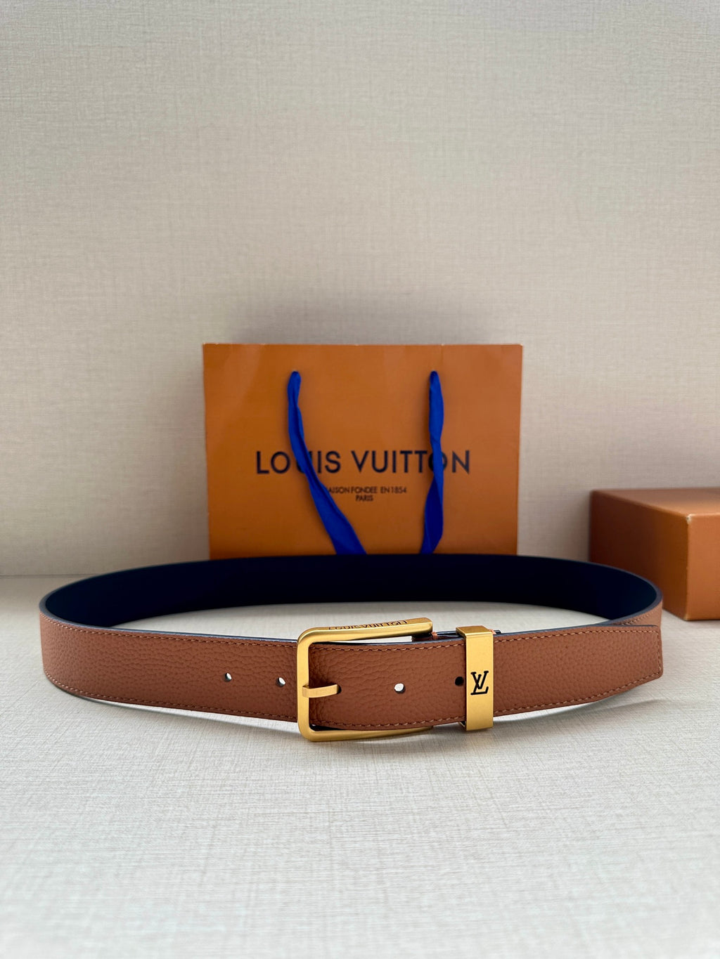 Louis Vuitton leather belt with tan strap and gold-tone buckle
