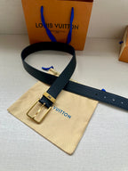 Louis Vuitton belt with dark blue leather strap and gold-tone buckle on dust bag.