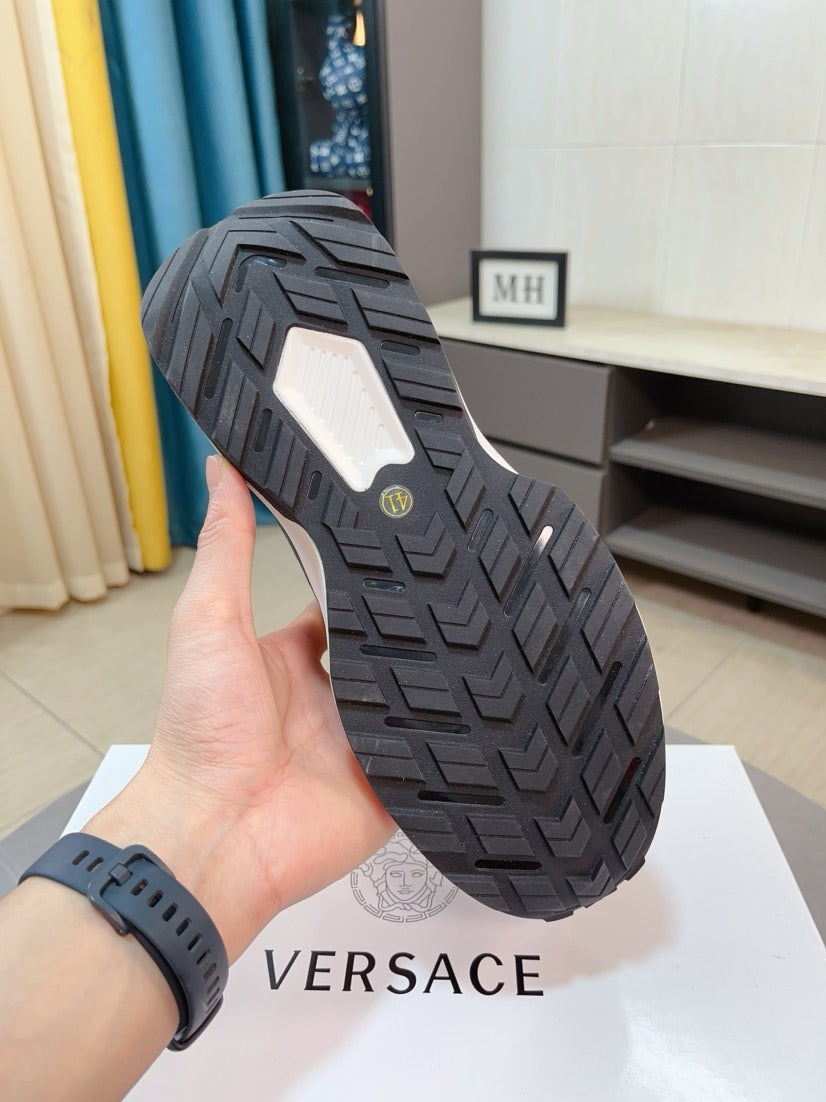 Black sneaker outsole with textured tread pattern and geometric grip grooves.