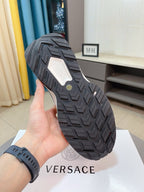 Black sneaker outsole with textured tread pattern and geometric grip grooves.