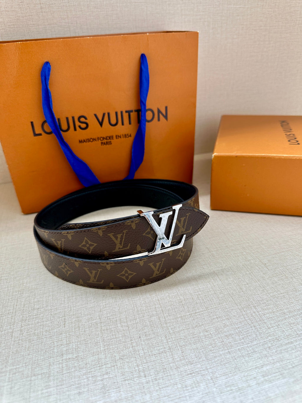 Monogram belt with dark canvas strap and gold-tone LV buckle with gift box