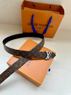 Monogram belt with dark strap and gold-tone LV buckle with orange box insert