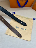 Monogram belt straps with LV buckle and metal pin on a beige pouch