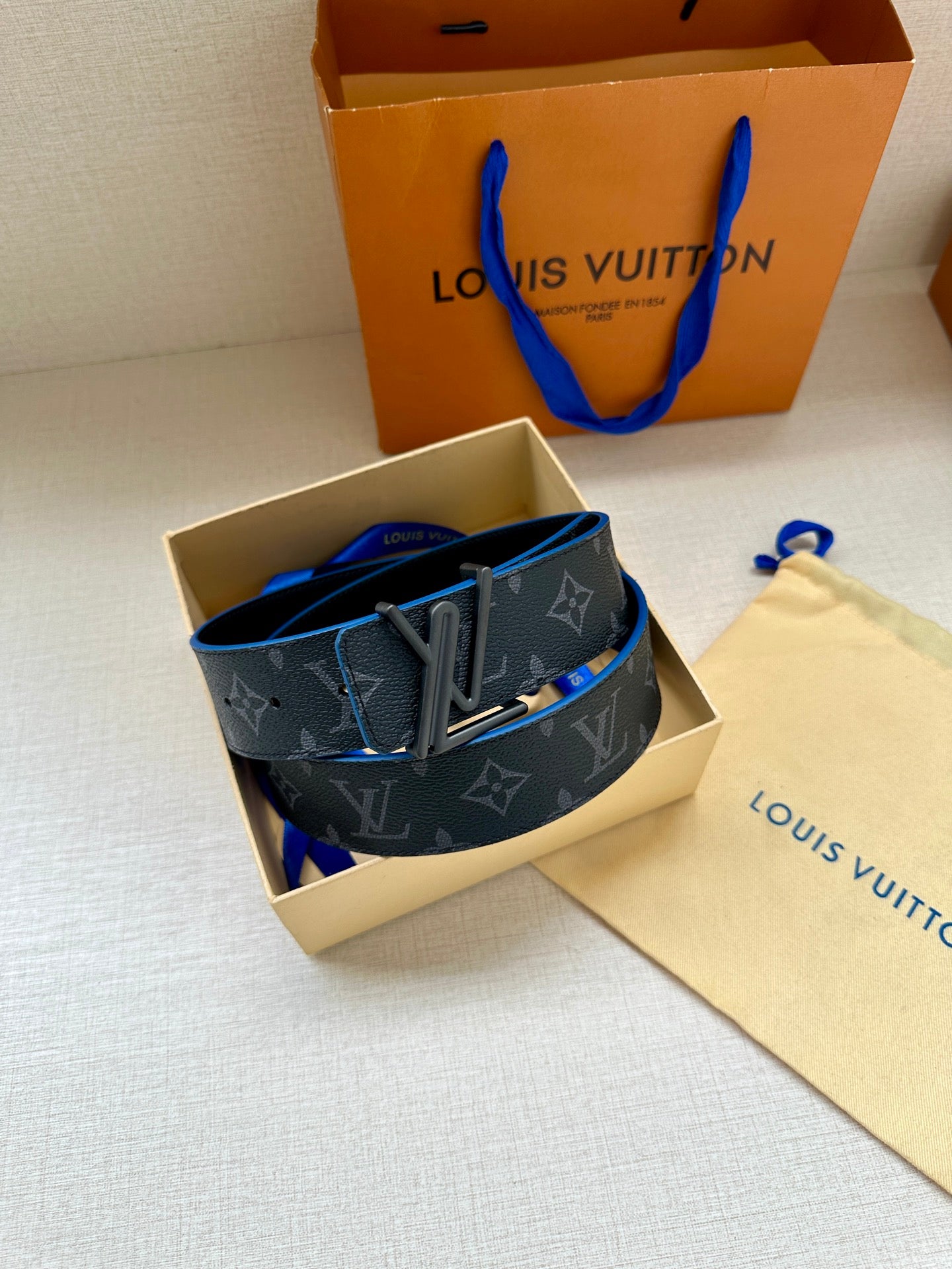 Louis Vuitton belt, dark monogram canvas with blue trim and silver buckle