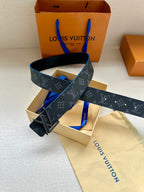 Louis Vuitton belt with dark monogram pattern, blue trim, and oversized silver buckle