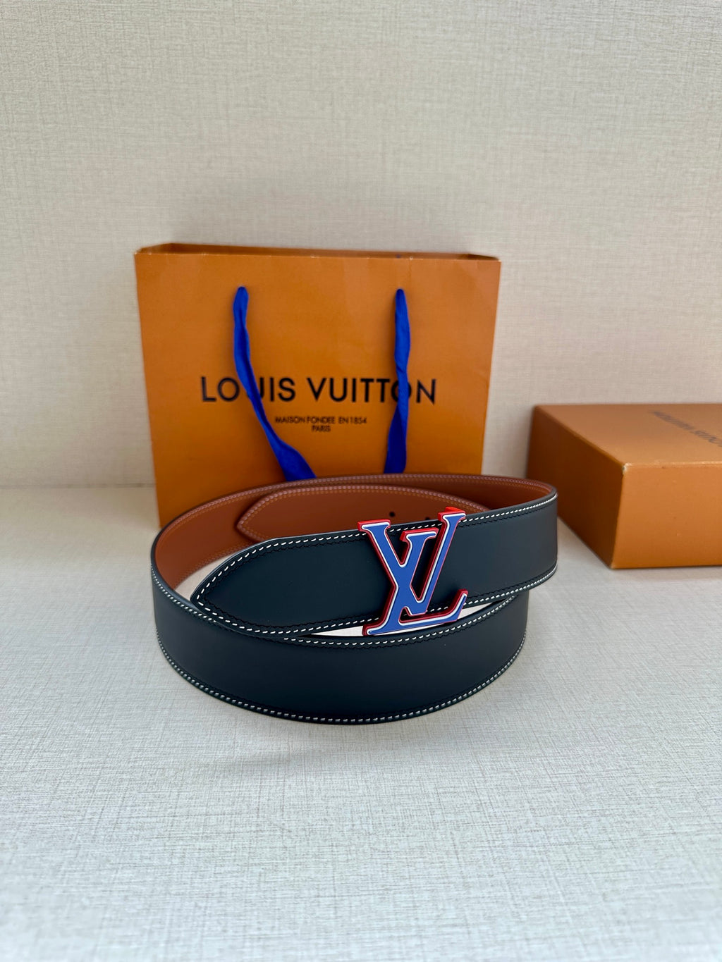 Dark blue leather belt with LV monogram buckle and contrast stitching