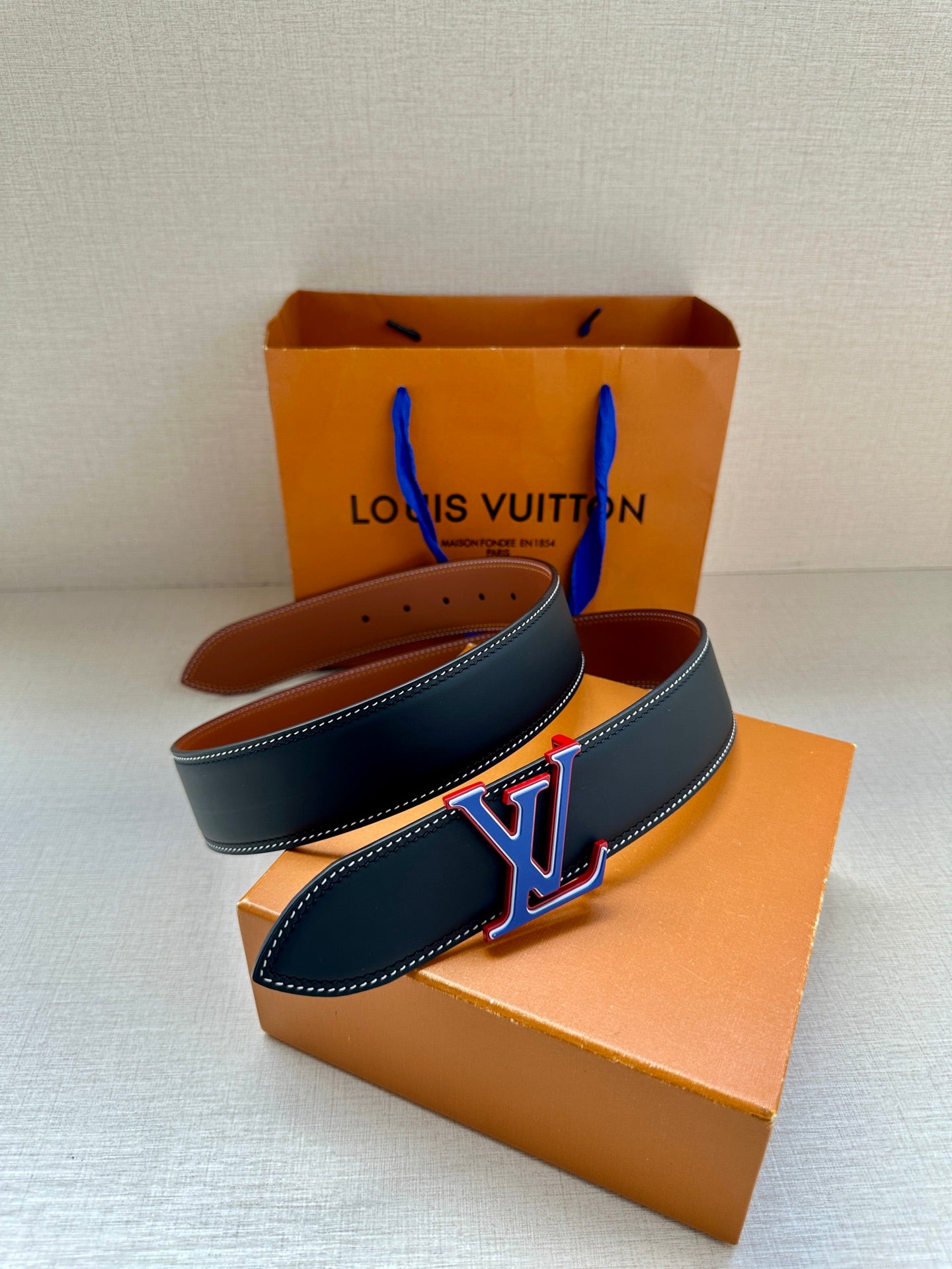 Leather belt set: dark blue and tan belts with LV monogram buckles